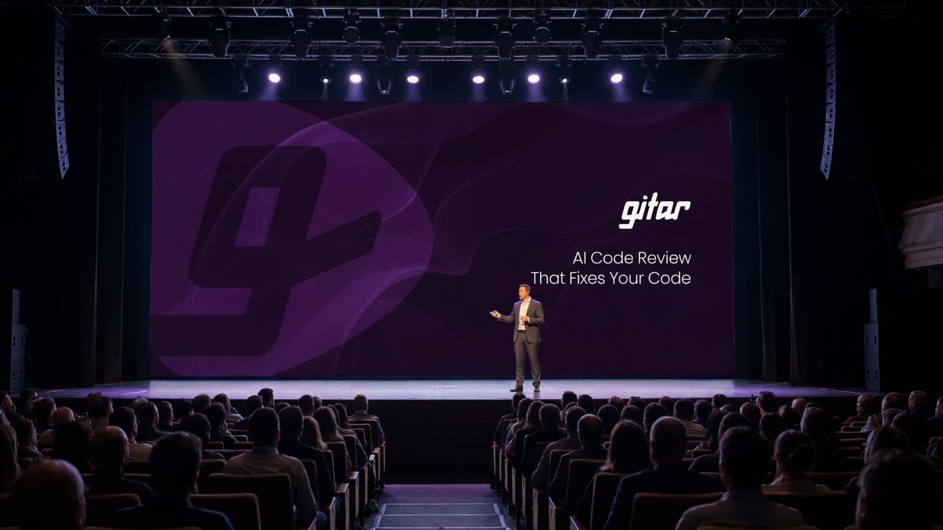 A Gitar keynote on stage, the brand filling the screen behind the speaker